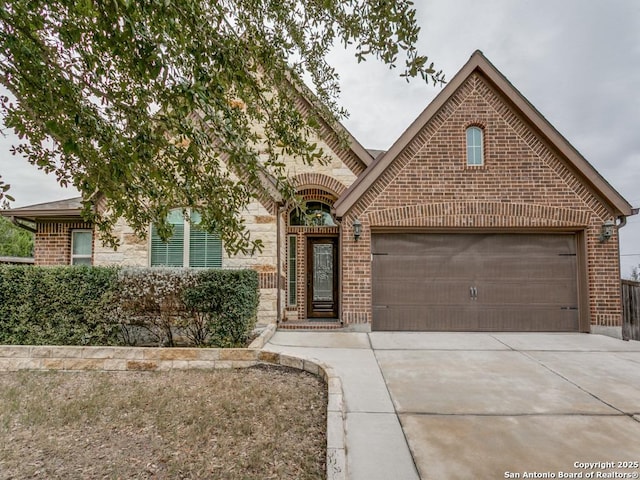 view of front of home with brick siding, concrete driveway, and an attached garage