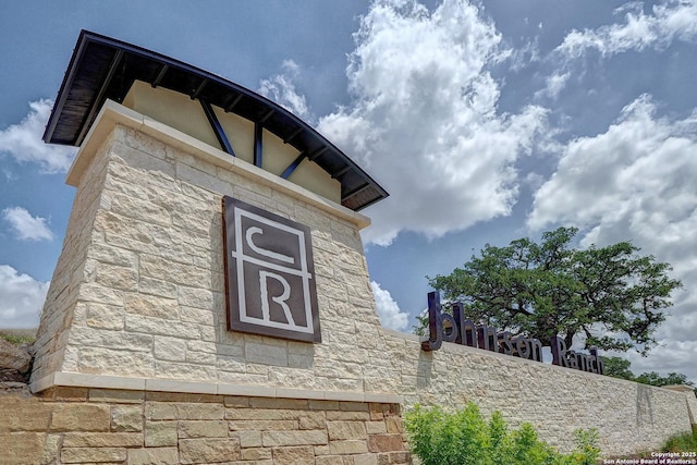 exterior details with stone siding and fence