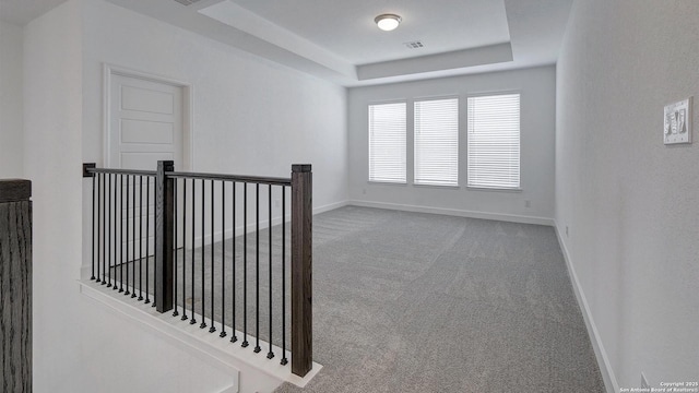 12322 Fort Jyn, San Antonio, TX 78245 - hallway featuring an upstairs landing, carpet, and a tray ceiling