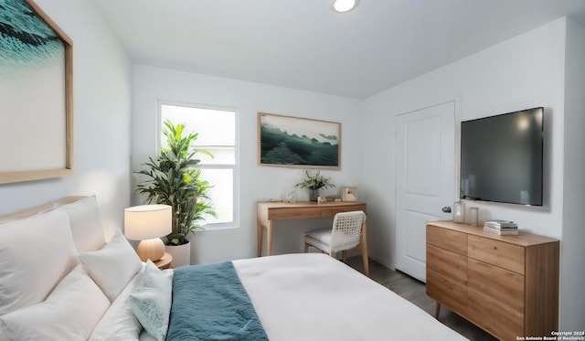 bedroom with dark wood finished floors