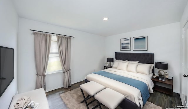 bedroom with dark wood-style floors, baseboards, and recessed lighting