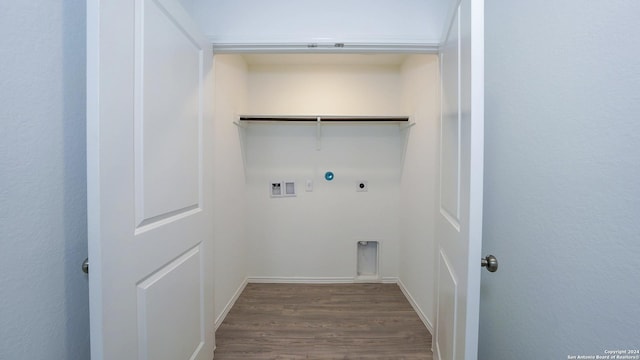 laundry area featuring laundry area, hookup for a gas dryer, wood finished floors, hookup for an electric dryer, and washer hookup