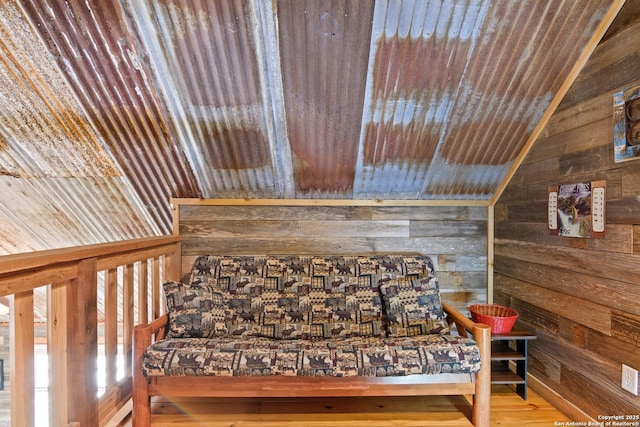 interior space featuring lofted ceiling, wooden ceiling, wooden walls, and wood finished floors