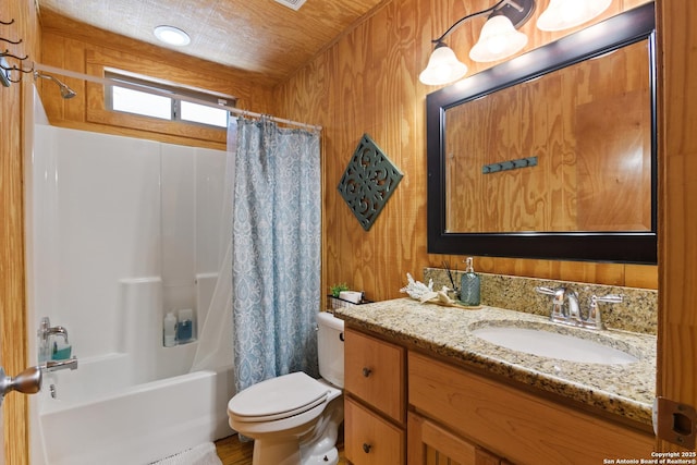 full bath featuring toilet, shower / tub combo with curtain, and vanity