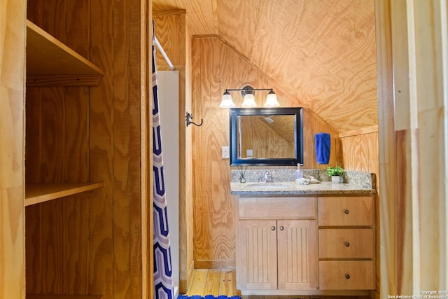 bathroom with wooden walls and vanity