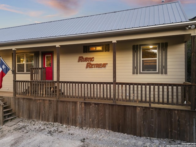 view of front of property with covered porch and metal roof