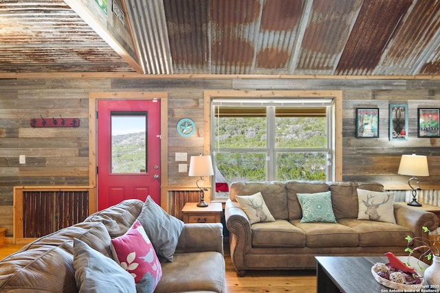 living room featuring wood finished floors and wooden walls