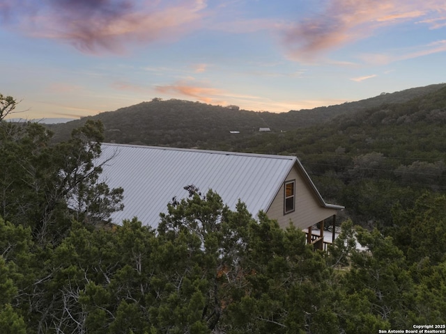 exterior space with metal roof and a mountain view