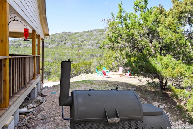 view of yard featuring a mountain view and a fire pit