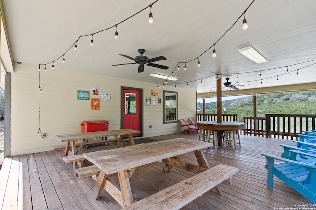 wooden deck featuring a ceiling fan and outdoor dining space