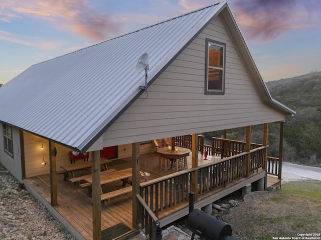 exterior space with metal roof and a wooden deck