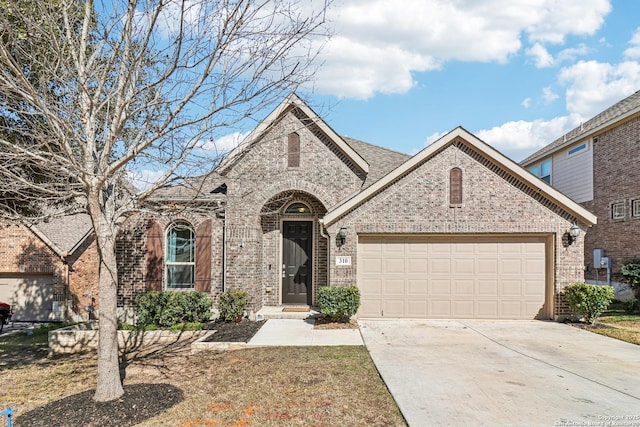 view of front facade featuring driveway, brick siding, and an attached garage