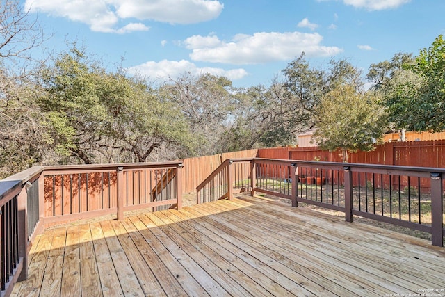 deck with a fenced backyard