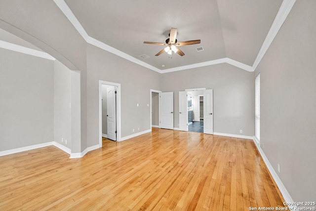 interior space with visible vents, baseboards, vaulted ceiling, crown molding, and light wood-style floors