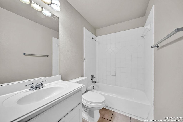 full bathroom with a textured wall, toilet, shower / tub combination, tile patterned flooring, and vanity