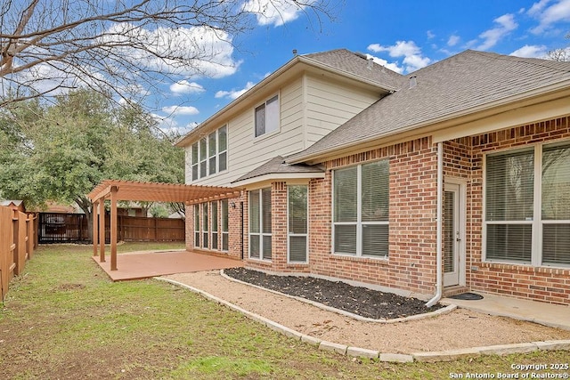 back of house featuring a patio, a fenced backyard, brick siding, roof with shingles, and a pergola