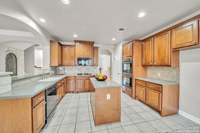 kitchen with visible vents, dishwasher, a center island, a peninsula, and a sink