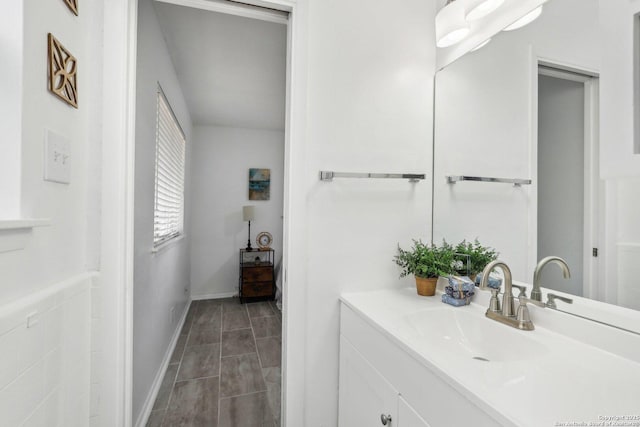 bathroom with vanity and baseboards