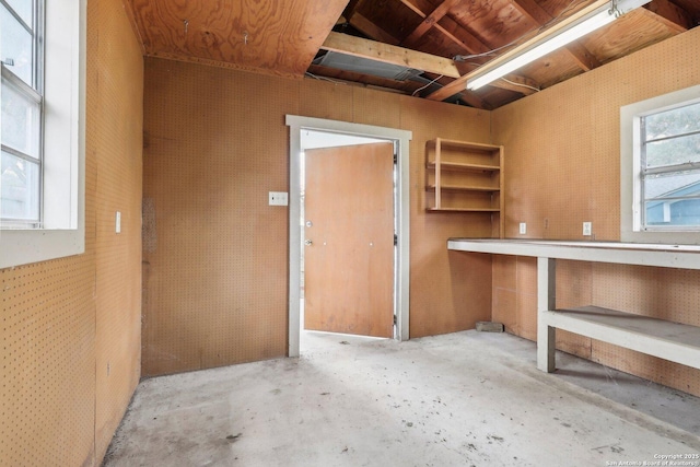 interior space featuring unfinished concrete floors and a workshop area