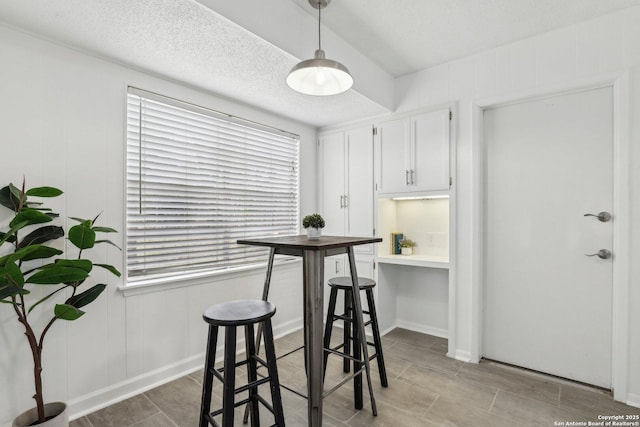 dining area featuring a textured ceiling