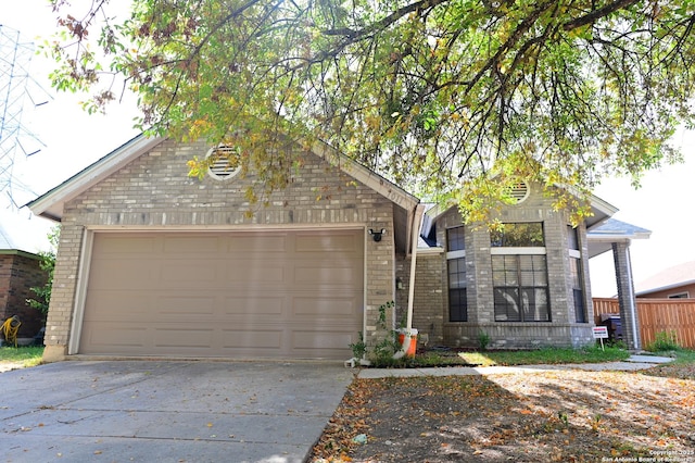 view of front of property with concrete driveway, brick siding, and an attached garage