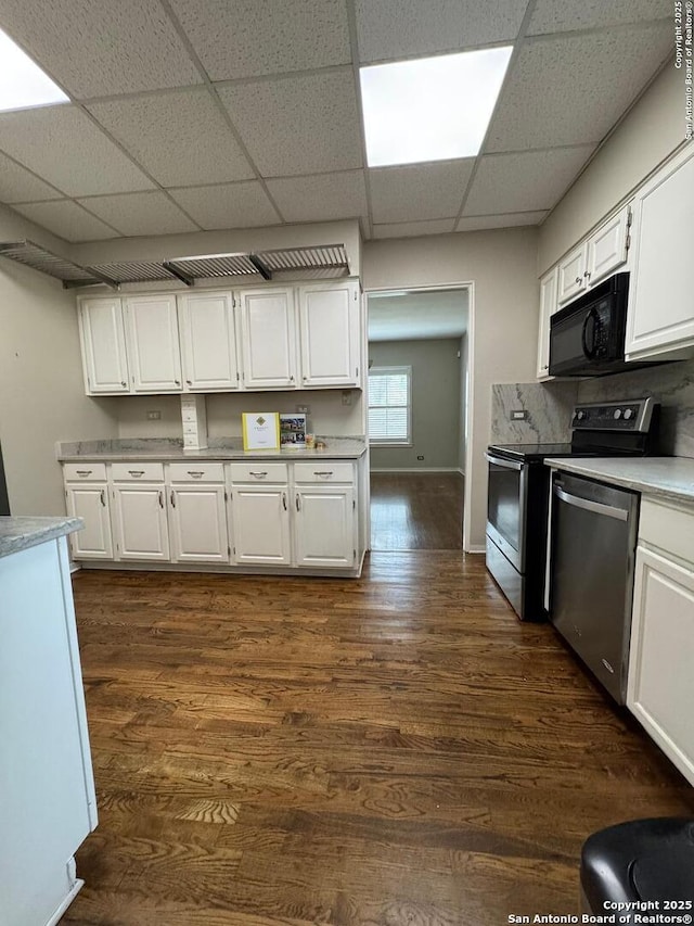 kitchen featuring white cabinets, electric range oven, black microwave, and dishwasher