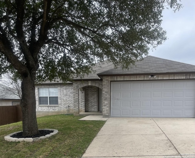 ranch-style home featuring a garage, brick siding, fence, concrete driveway, and roof with shingles