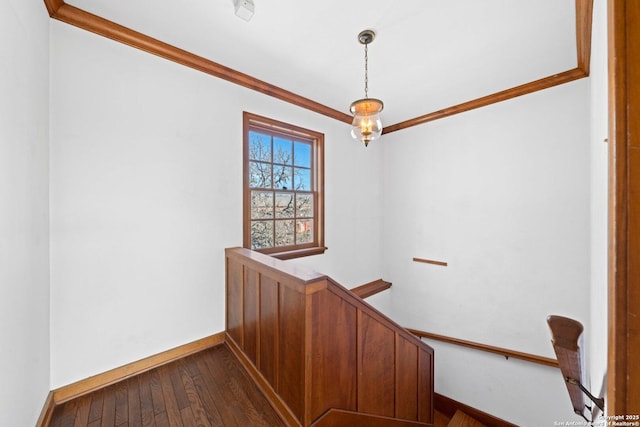 stairs featuring baseboards, wood finished floors, and crown molding