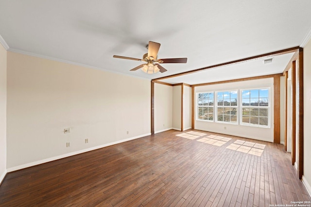 empty room with baseboards, visible vents, a ceiling fan, ornamental molding, and wood finished floors