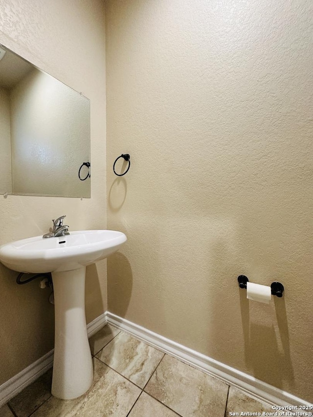 bathroom with tile patterned flooring and baseboards