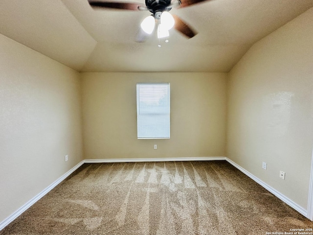 spare room featuring carpet floors, baseboards, a ceiling fan, and lofted ceiling