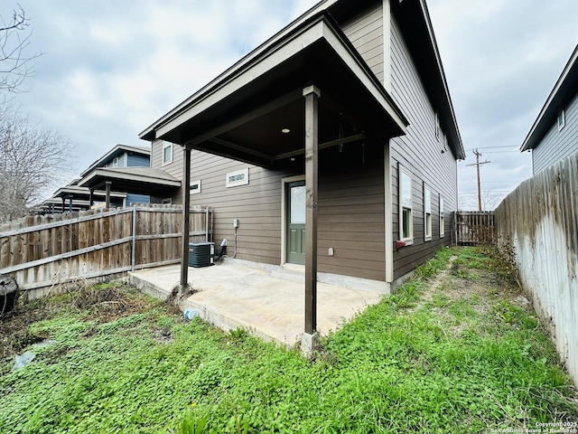 rear view of property with a patio and a fenced backyard