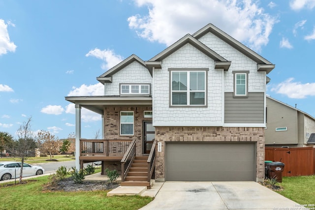 view of front of home with driveway, a garage, brick siding, fence, and a front yard