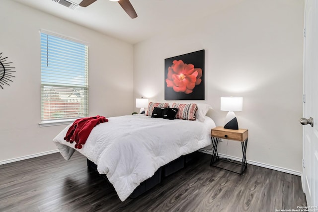 bedroom featuring ceiling fan, dark wood-type flooring, visible vents, and baseboards