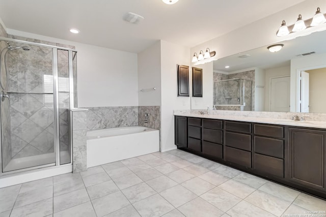 bathroom with a stall shower, double vanity, visible vents, and a bath