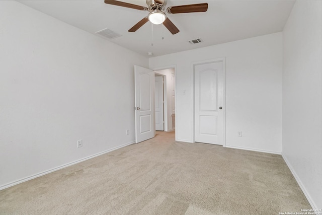 unfurnished bedroom with light carpet, ceiling fan, visible vents, and baseboards