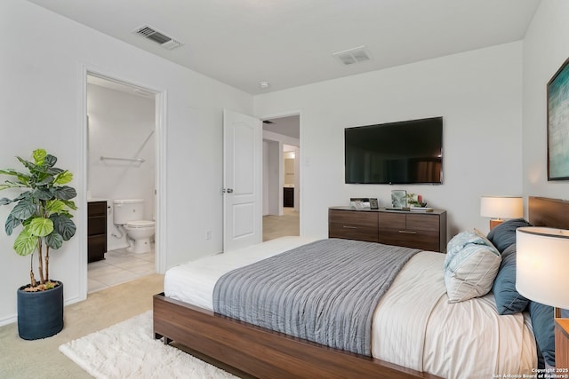 bedroom featuring light colored carpet, visible vents, and connected bathroom