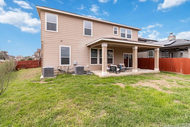 rear view of house featuring a yard, a fenced backyard, cooling unit, and a patio