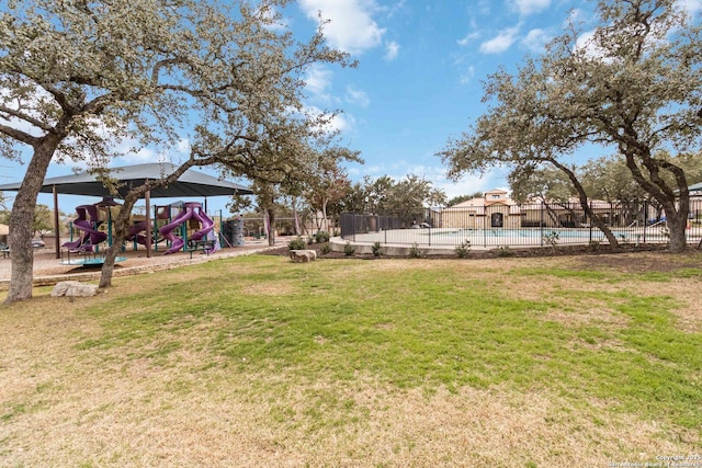 view of yard featuring fence and playground community