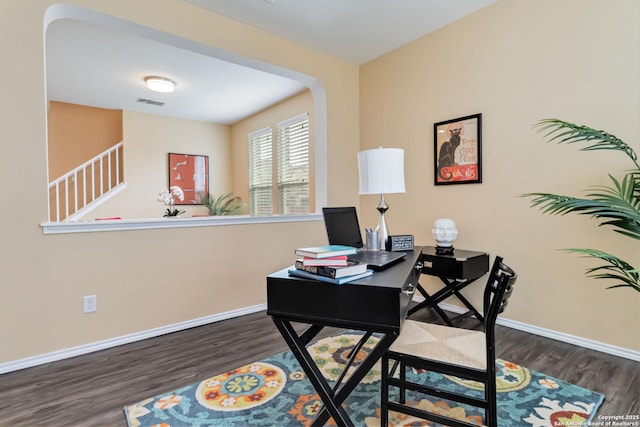 office area featuring dark wood-style floors, visible vents, and baseboards