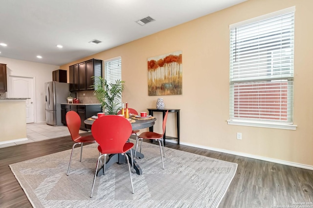 dining room with light wood-style flooring, visible vents, baseboards, and recessed lighting