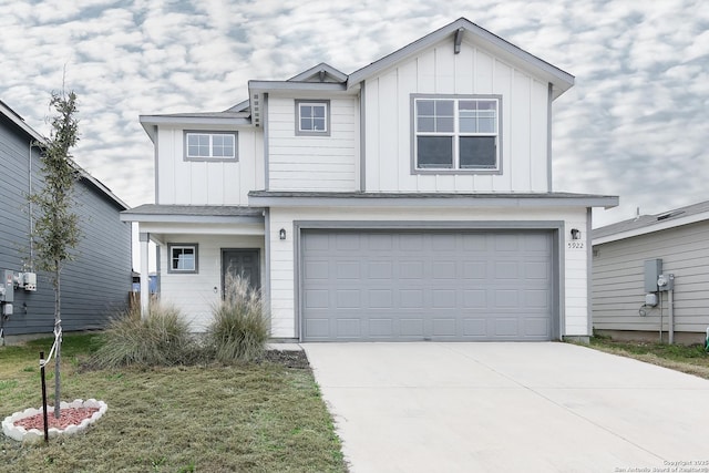 view of front of house featuring board and batten siding, concrete driveway, a front lawn, and an attached garage