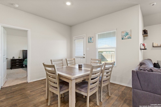 dining area featuring dark wood-style floors and baseboards