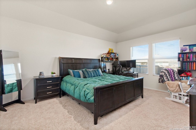 bedroom with baseboards and light colored carpet