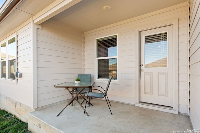 entrance to property with a patio area and outdoor dining space