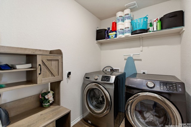 clothes washing area featuring laundry area, washer and clothes dryer, and baseboards