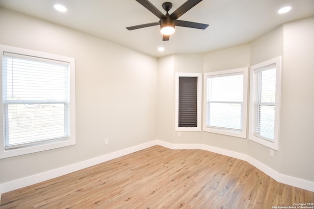 empty room with light wood-style floors, recessed lighting, and baseboards