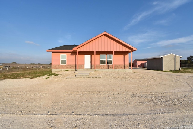 view of front of house featuring brick siding and board and batten siding