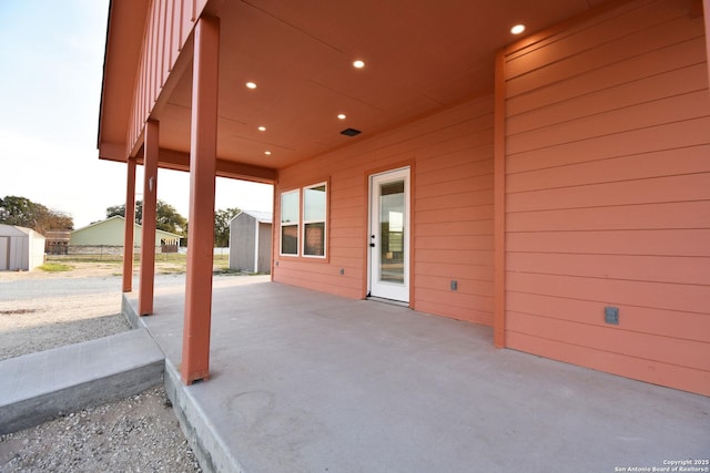 view of patio / terrace featuring an outdoor structure and a storage shed