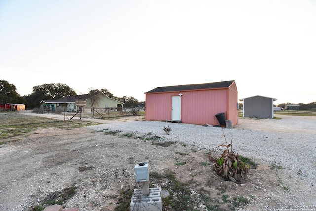 view of outbuilding with fence and an outbuilding